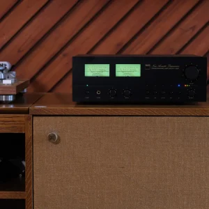 Ampli NAD C 3030 Stereophonic đặt trên loa Vestlyd V12C, đồng hồ VU màu xanh, phòng nội thất gỗ ấm