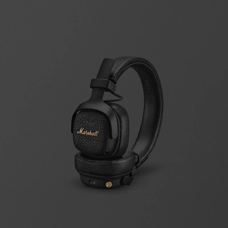 Marshall Milton A.N.C. đen gập gọn, logo đồng brass và núm điều khiển vàng trên nền xám