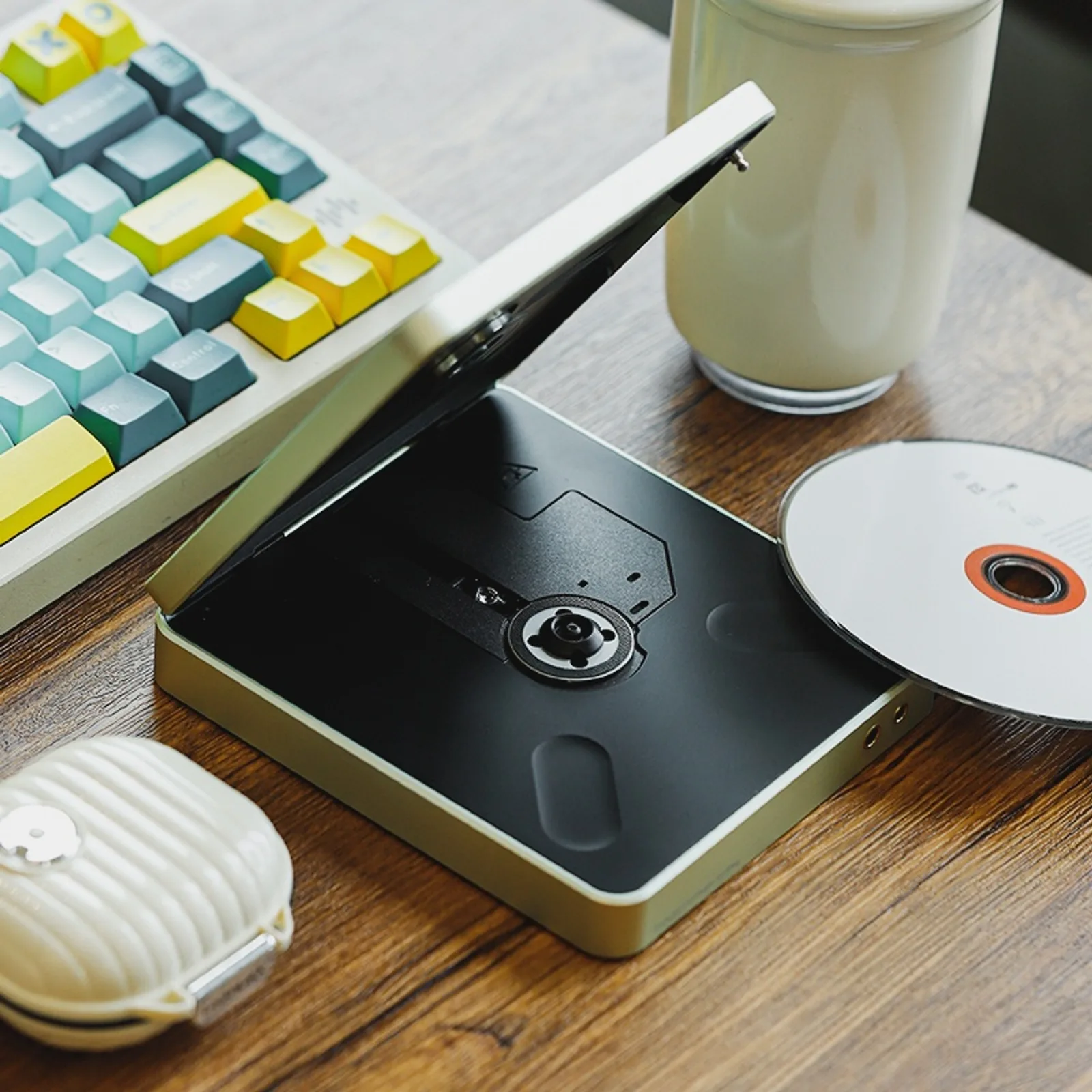 Shanling EC Play mở nắp, khay đĩa CD và ống kính quang học, đặt cạnh đĩa CD và bàn phím cơ