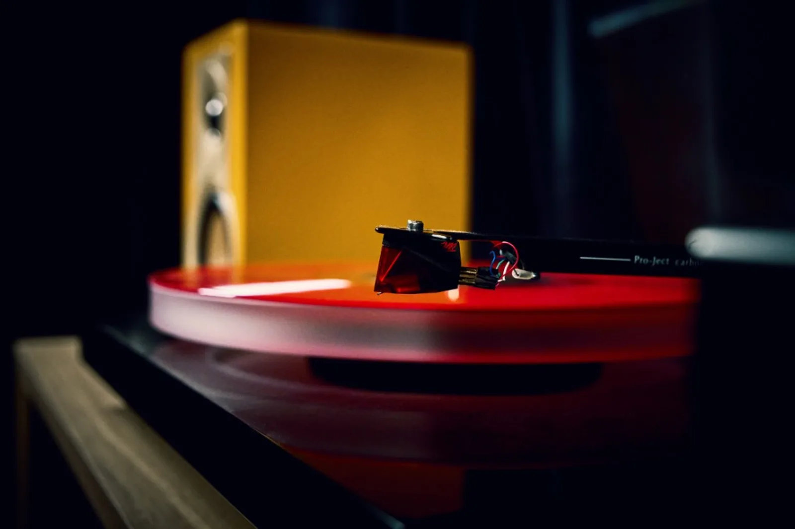 Loa DALI KUPID phía sau đầu đĩa than Pro-Ject với đĩa vinyl đỏ