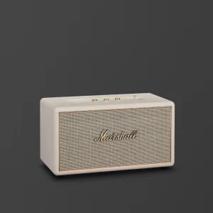 Loa Marshall Stanmore IV màu cream với lưới vải xám và viền vàng đồng trên nền tối