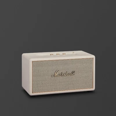 Loa Marshall Stanmore IV màu cream với lưới vải xám và viền vàng đồng trên nền tối