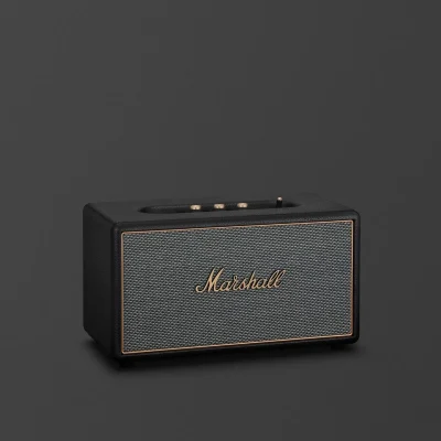 Loa Marshall Stanmore IV màu đen với lưới vải xám và logo vàng đồng trên nền tối